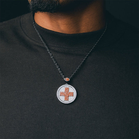 Man wearing the Eminem Recovery diamond cross pendant on a chain over a black tee