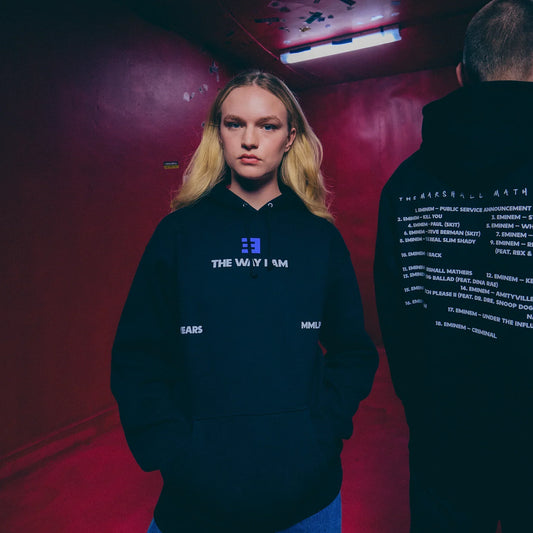 Woman wearing the black Eminem MMLP25 hoodie with blue The Way I Am chest print