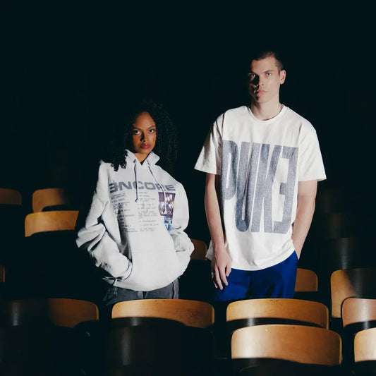 Two models in Eminem Encore PUKE T-shirt and hoodie among theatre seats