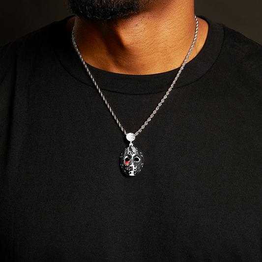 Man wearing the silver Eminem hockey mask pendant and chain over a black T-shirt