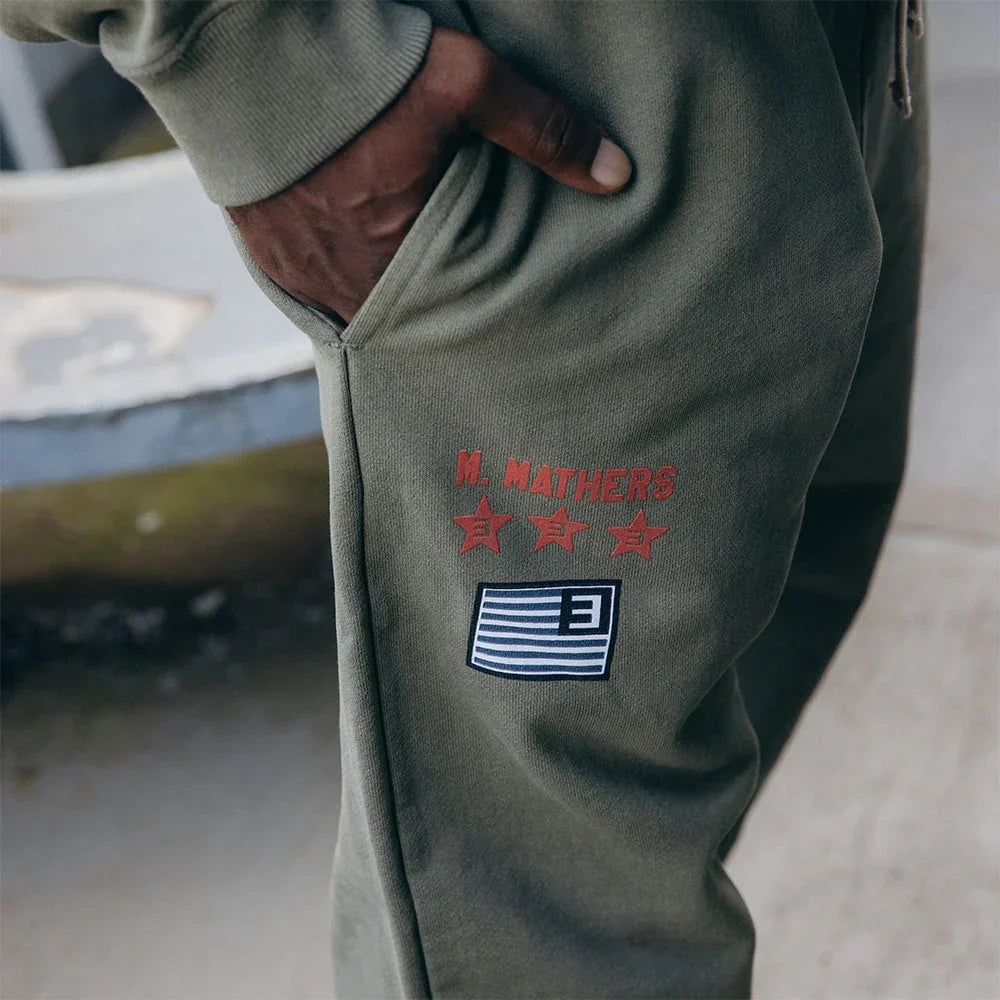 Pocket and print detail on the burnt olive Eminem Kamikaze x Standard Issue sweatpants