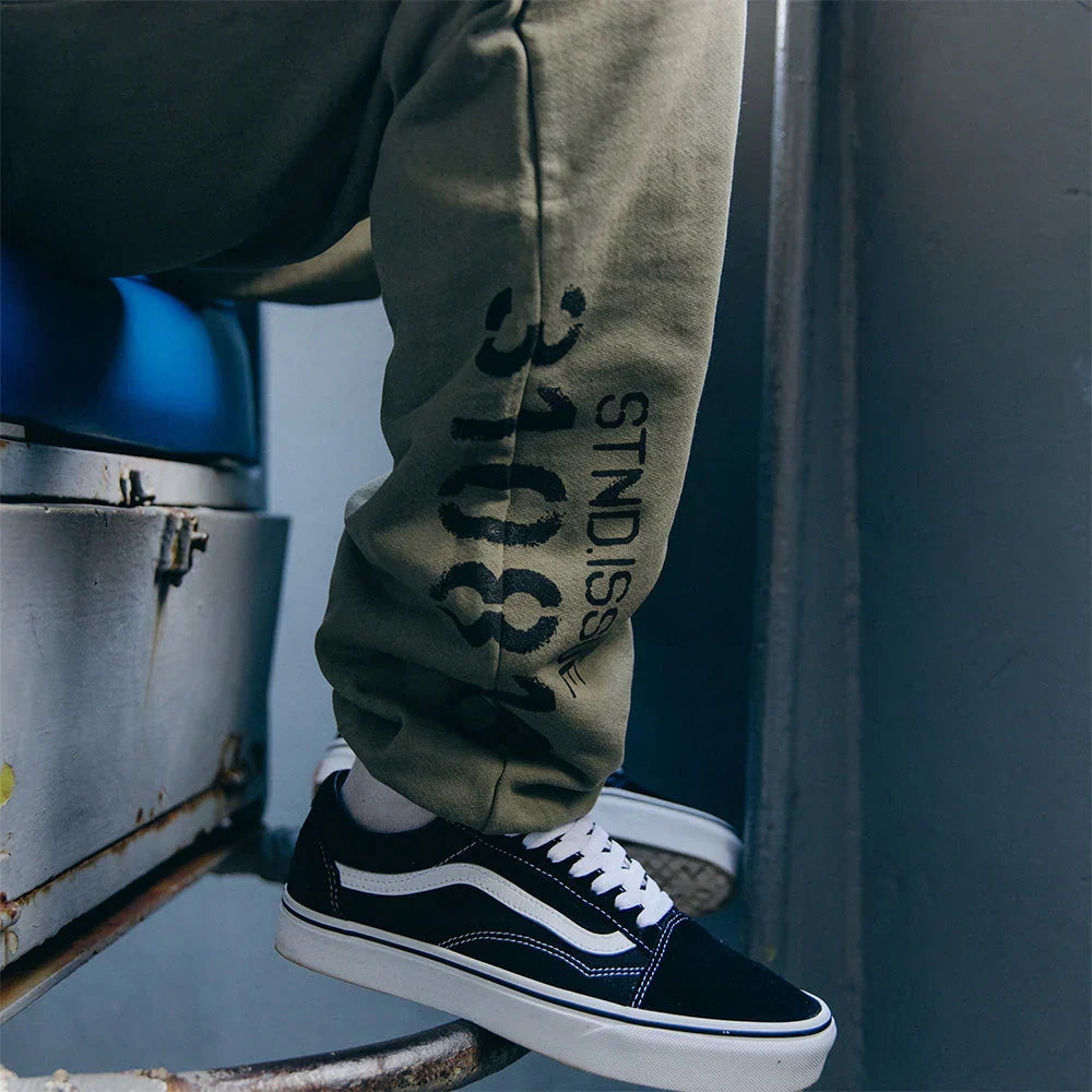 Leg print reading 310818 Stnd. Issue on the burnt olive Eminem Kamikaze sweatpants