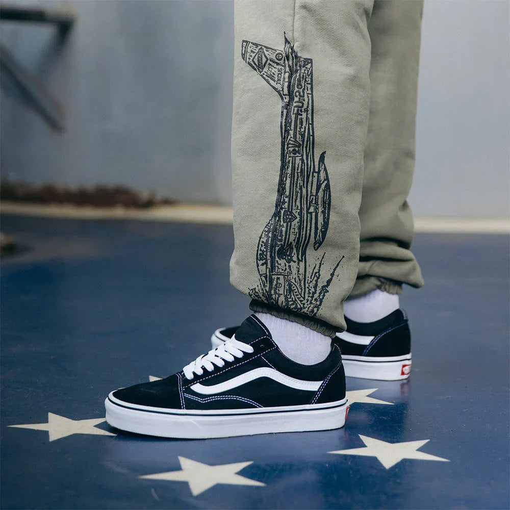 Tonal bomb graphic on the leg of the burnt olive Eminem Kamikaze sweatpants