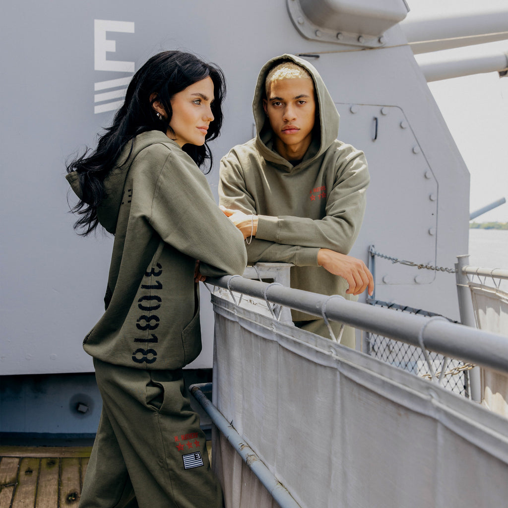 Models in burnt olive Eminem Kamikaze hoodies showing the 310818 sleeve print