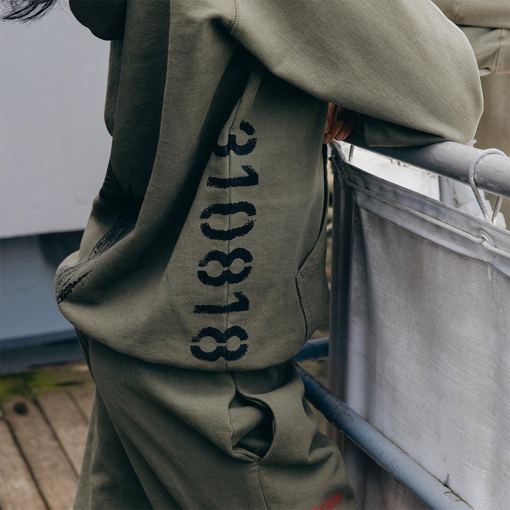 Sleeve print detail reading 310818 on the burnt olive Eminem Kamikaze hoodie