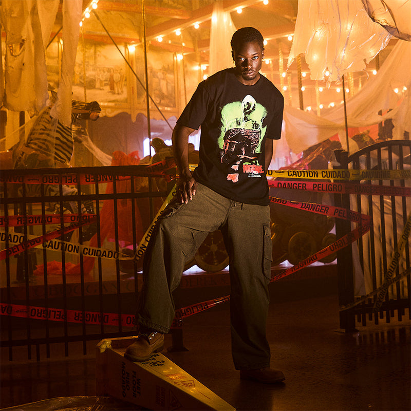 Man wearing the black Eminem Nightmare on 8 Mile T-shirt with horror poster graphic