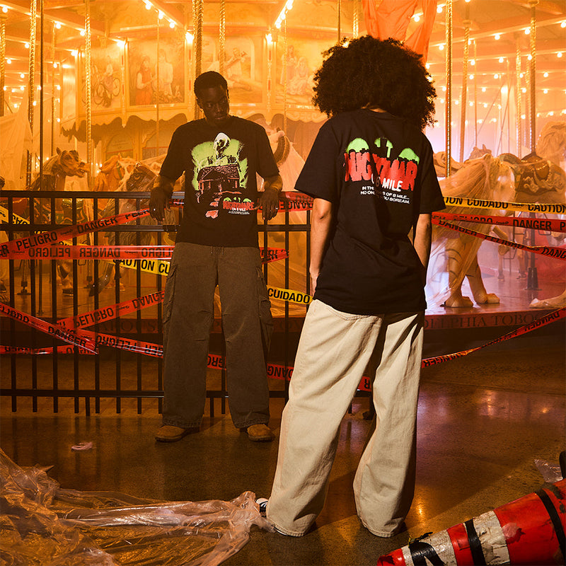 Two models in Eminem Nightmare on 8 Mile T-shirts at a fairground at night