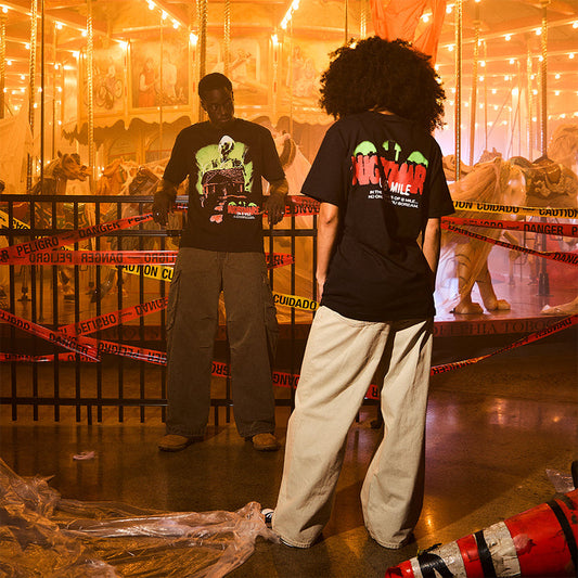 Two models in Eminem Nightmare on 8 Mile T-shirts at a fairground at night