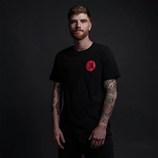 Man wearing the black Eminem Basic E-Shirt, minimal red E logo left-chest print