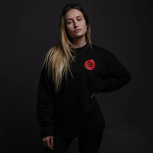 Woman wearing the black Eminem Basic E Logo crewneck sweatshirt with red chest logo