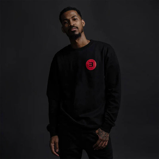 Man wearing the black Eminem Basic E Logo crewneck sweatshirt, small red E logo print