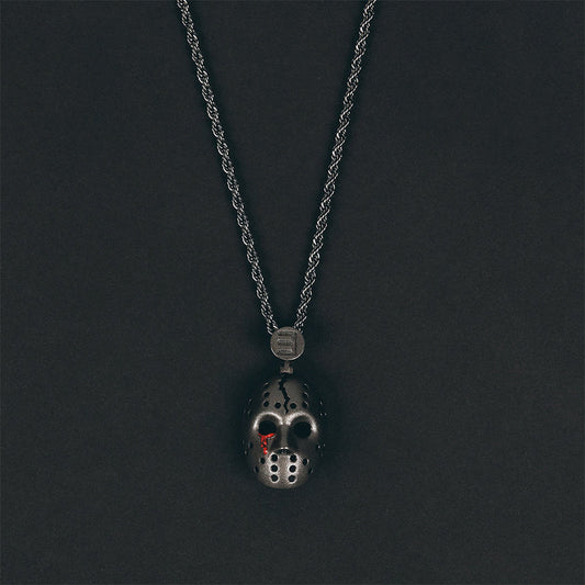 Eminem hockey mask pendant and chain photographed on a dark grey background