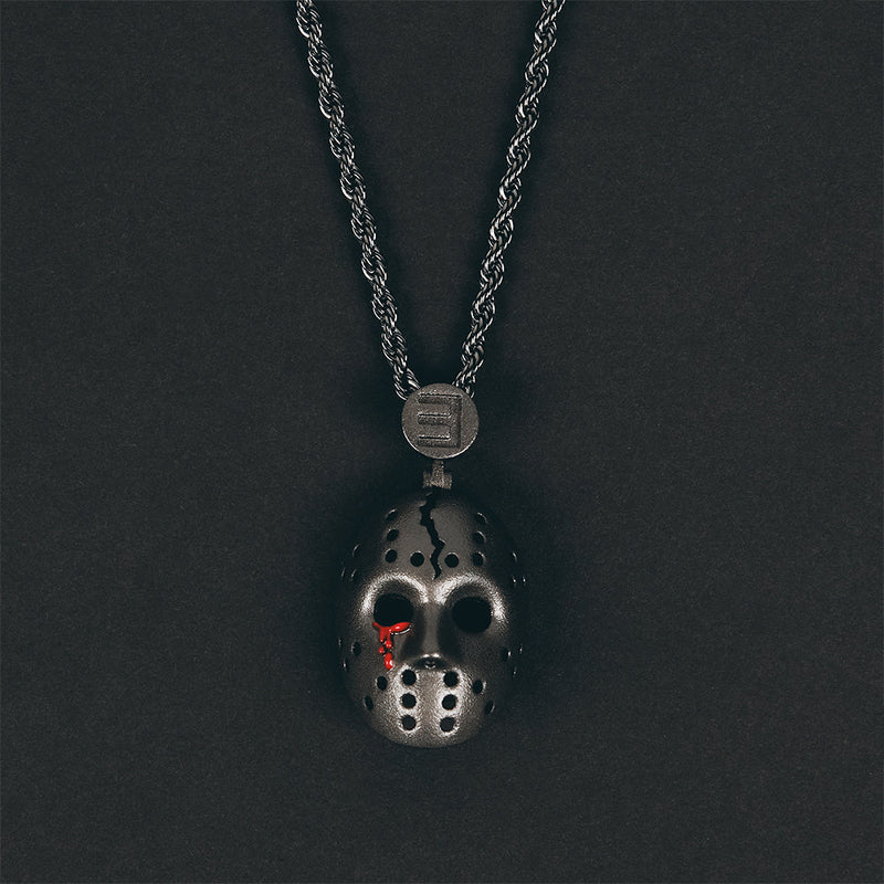 Close-up of the Eminem hockey mask pendant showing mask vents and red accents