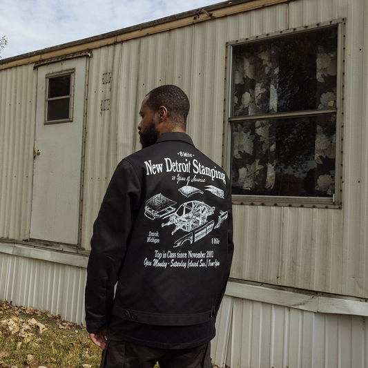 Back of black Eminem 8 Mile New Detroit Stamping Dickies work jacket worn by a model