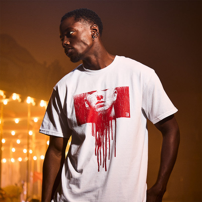 Man wearing the white Eminem Massacre T-shirt with red dripping portrait print