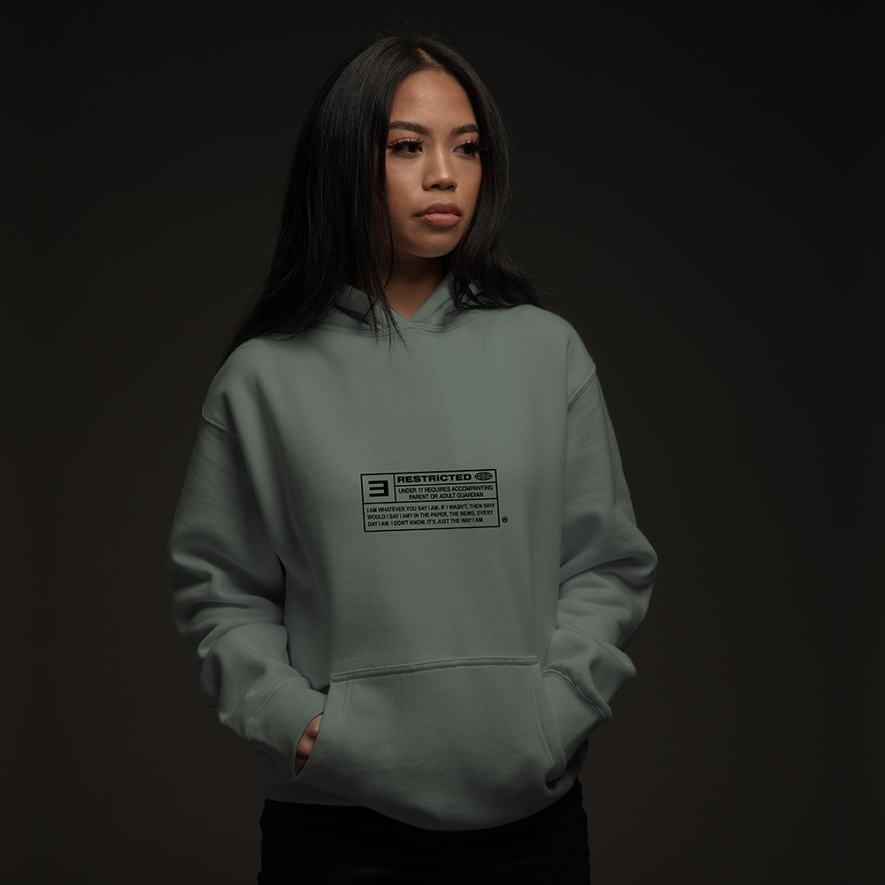 Woman wearing the sage green Eminem The Way I Am hoodie with small chest label print