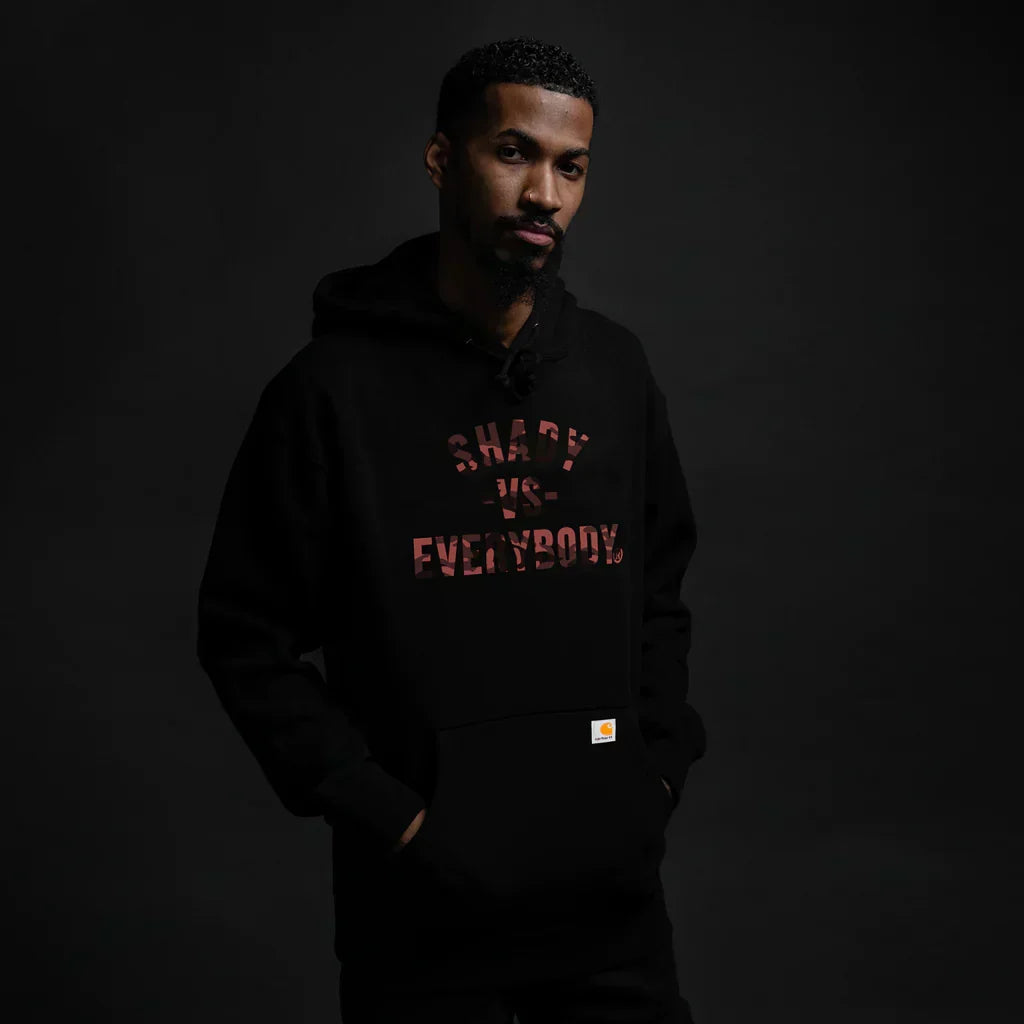 Man wearing the black Eminem Shady Vs Everybody hoodie with red chest lettering