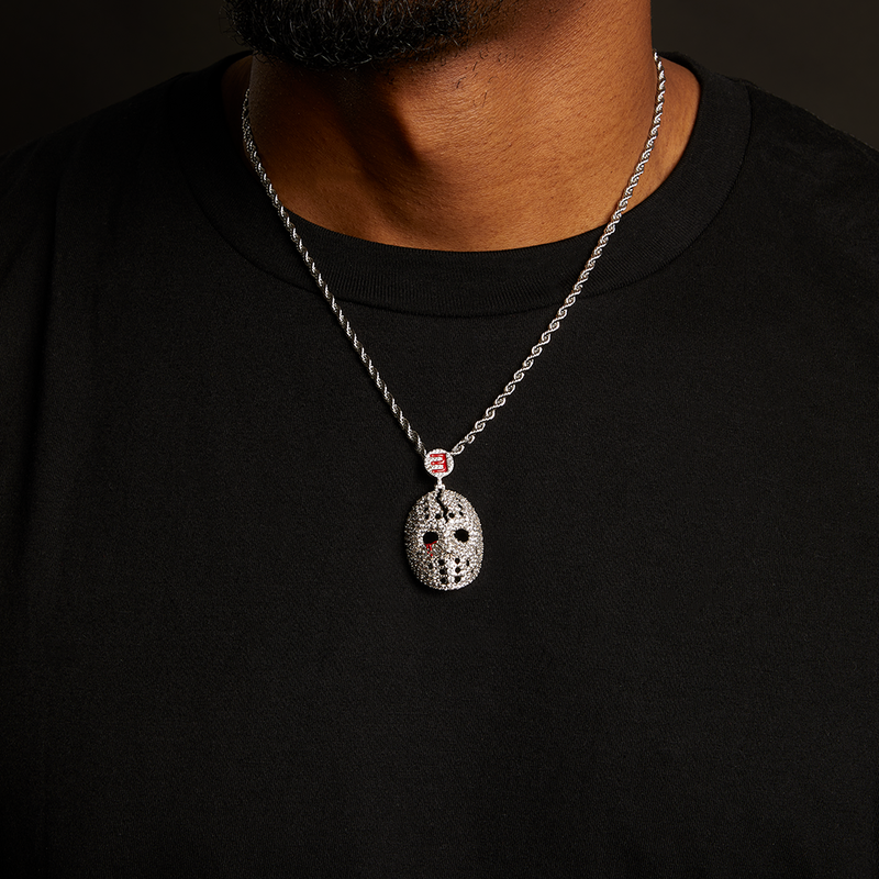 Man wearing the Eminem hockey mask diamond pendant and silver chain over a black tee