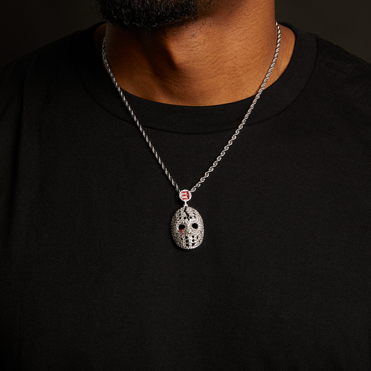 Man wearing the Eminem hockey mask diamond pendant and silver chain over a black tee