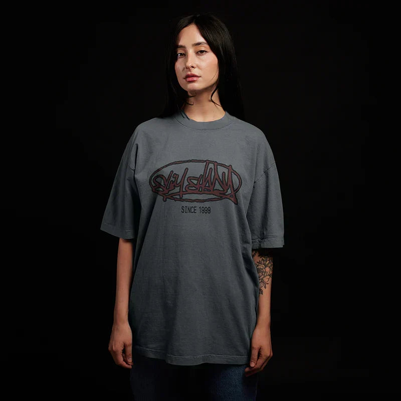 Woman wearing the grey Eminem Plz Stand T-shirt with red graffiti chest print