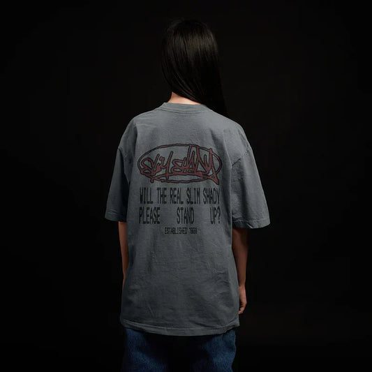 Back of the grey Eminem Plz Stand T-shirt worn by a model, graffiti and stencil text