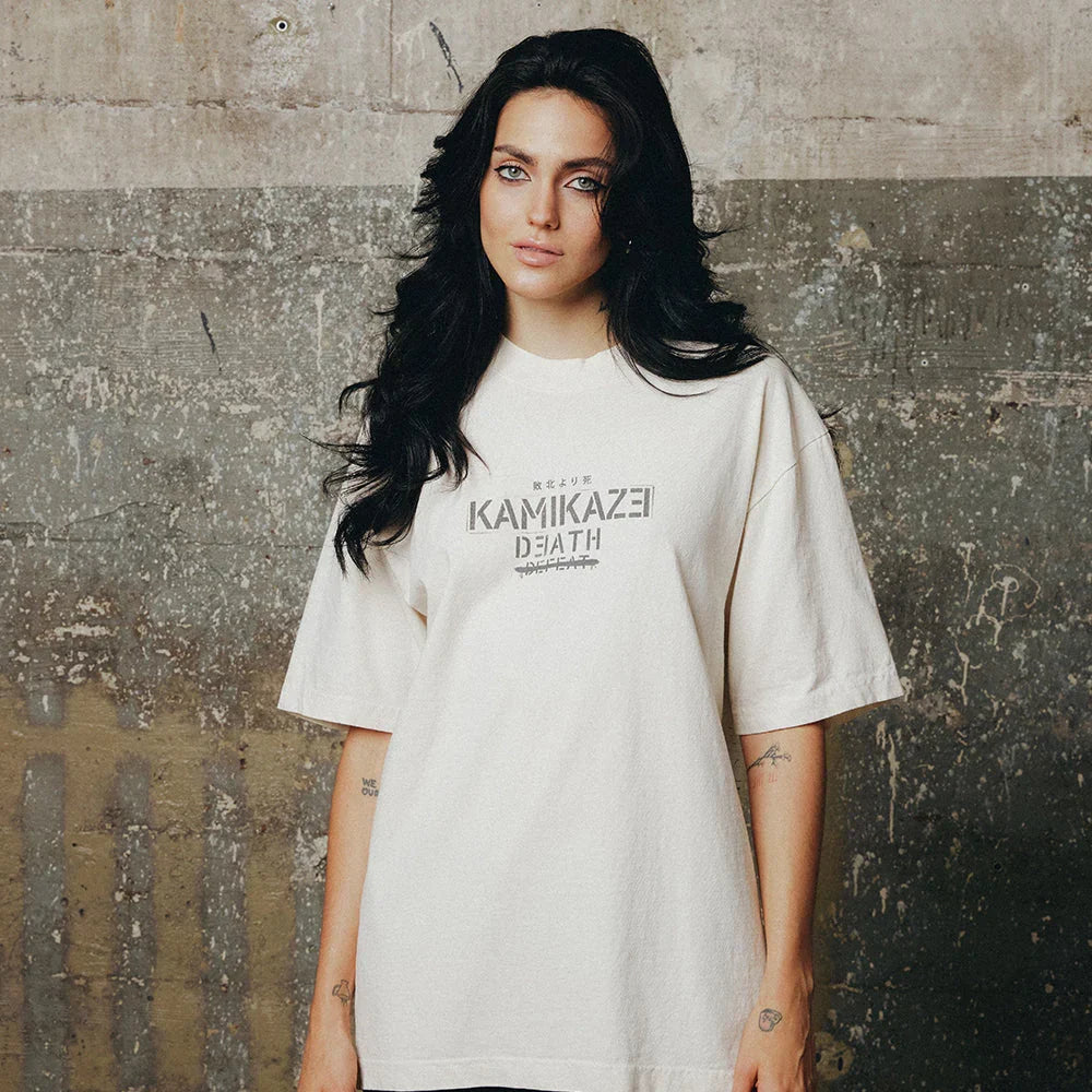 Woman wearing the cream Eminem Kamikaze Propaganda T-shirt, oversized fit