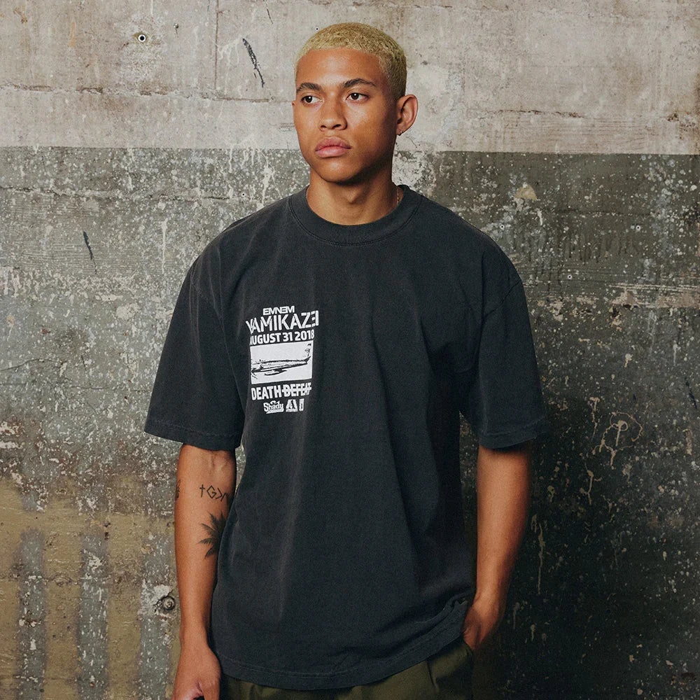 Man wearing the washed black Eminem Kamikaze Vintage Album T-shirt with chest panel print