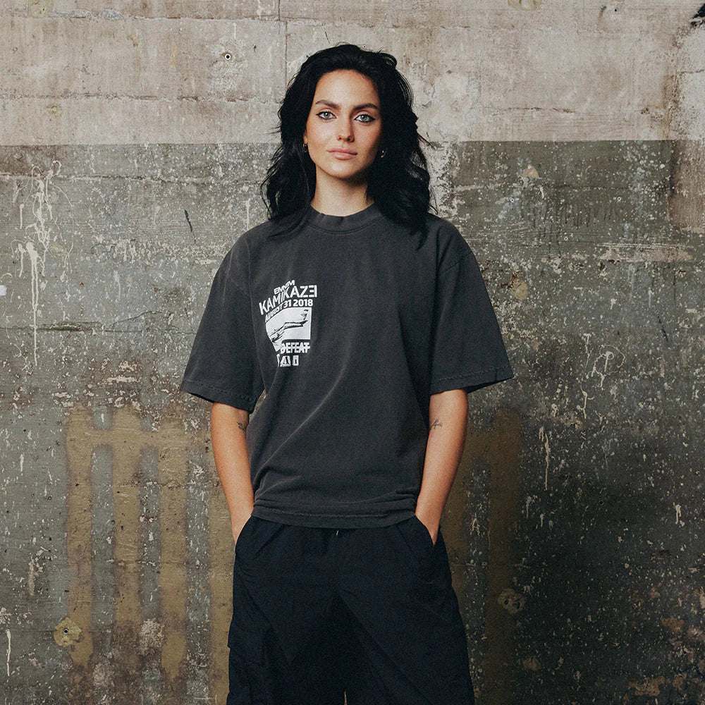 Woman wearing the washed black Eminem Kamikaze Vintage Album T-shirt, oversized fit