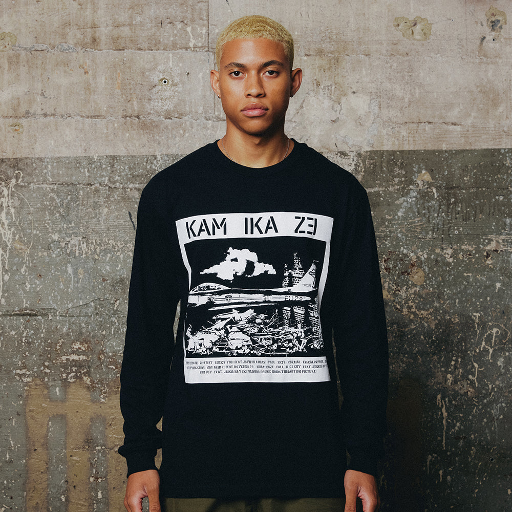 Man wearing the black Eminem Kamikaze Rubble long sleeve with white panel graphic