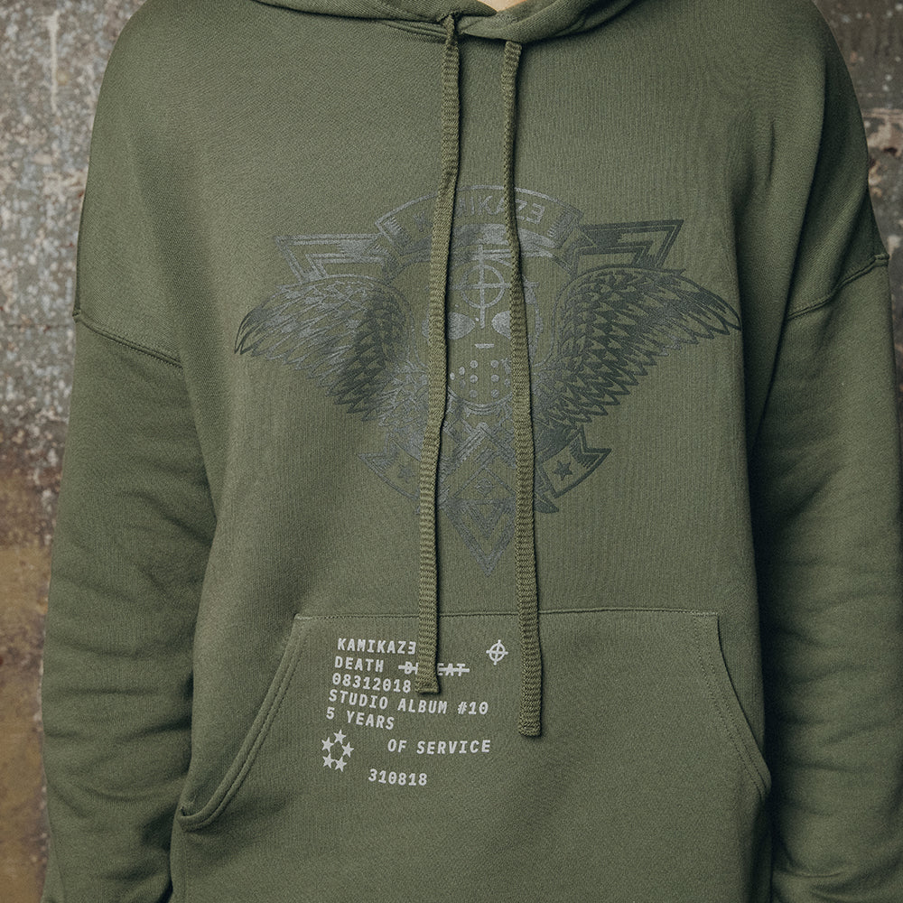 Close-up of the tonal crest and text print on the olive Eminem Kamikaze hoodie