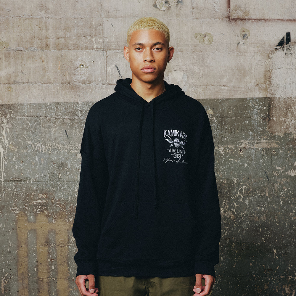 Man wearing the black Eminem Kamikaze Flag hoodie with white chest crest print