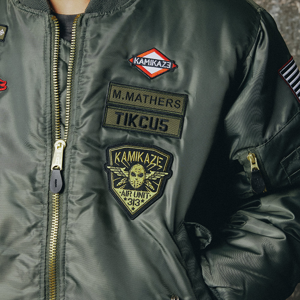 Patch detail on the Eminem Kamikaze bomber jacket, M. Mathers and Air Unit badges