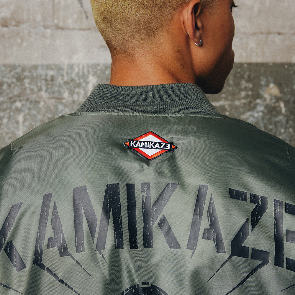 Back yoke detail of the Eminem Kamikaze bomber jacket with red diamond patch and lettering