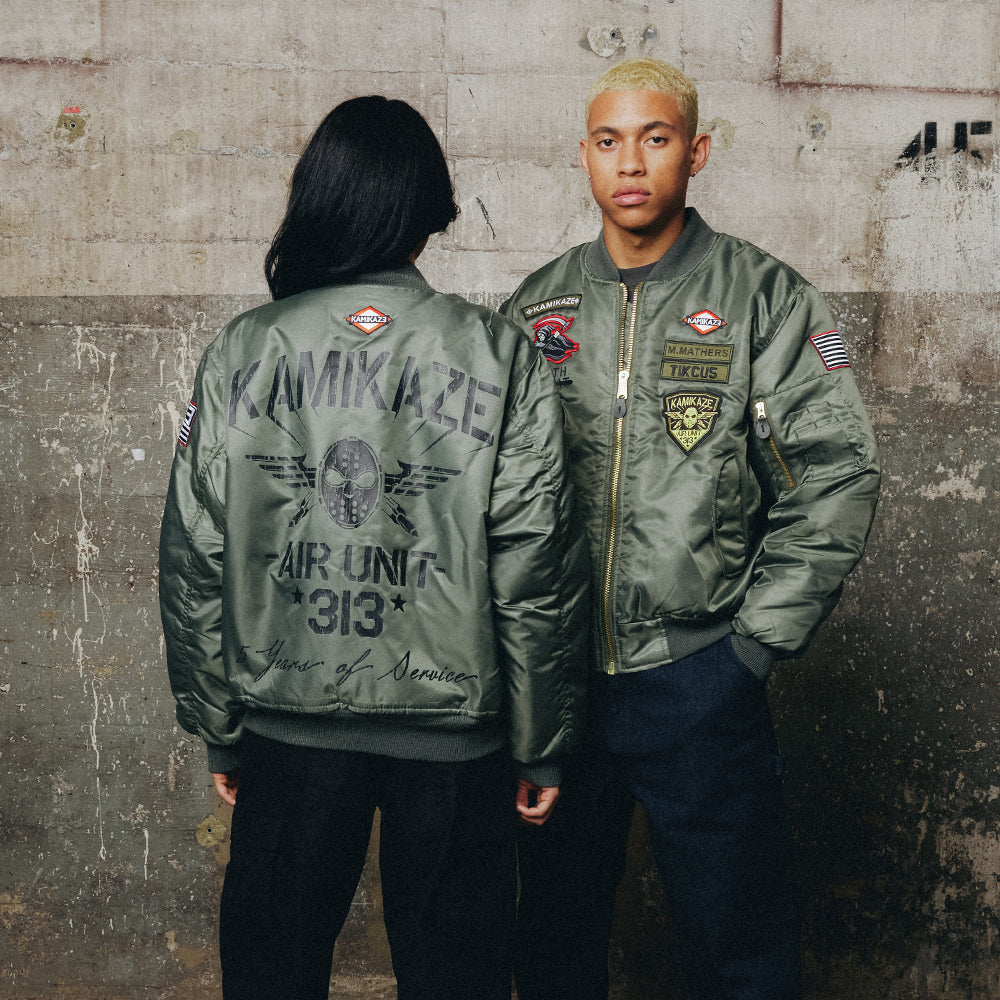Two models in green Eminem Kamikaze Pilot bomber jackets with Air Unit 313 back print