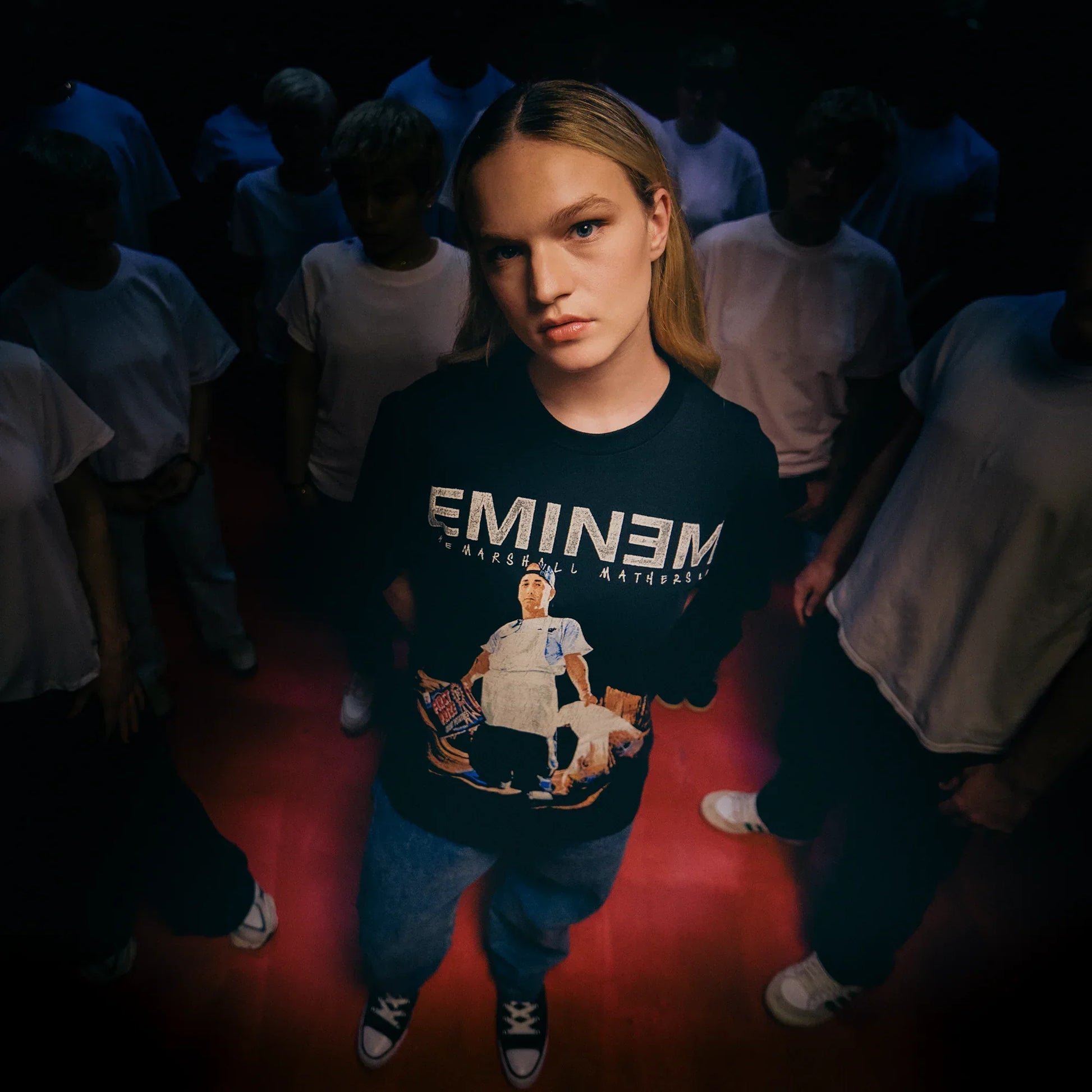Woman wearing the black Eminem MMLP25 Tracklist T-shirt with white logo and photo print