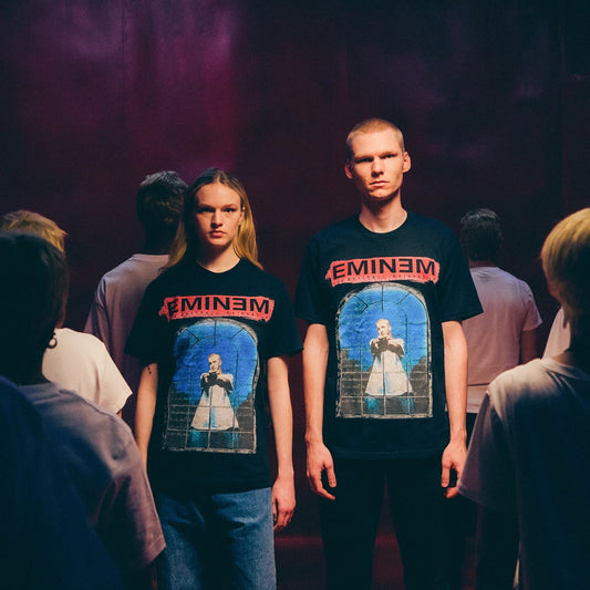 Models wearing black Eminem MMLP25 Window T-shirts with red logo and stained-glass print