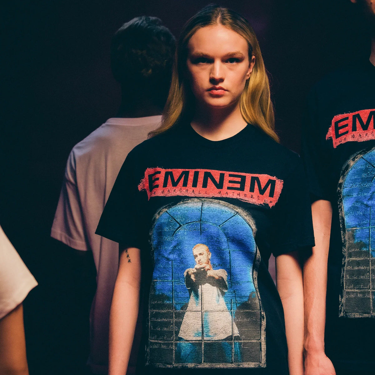 Close-up of the red Eminem logo and stained-glass window print on the MMLP25 T-shirt