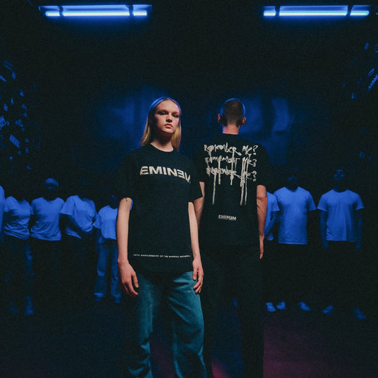 Models in black Eminem MMLP25 Remember Me T-shirts in a blue-lit crowd