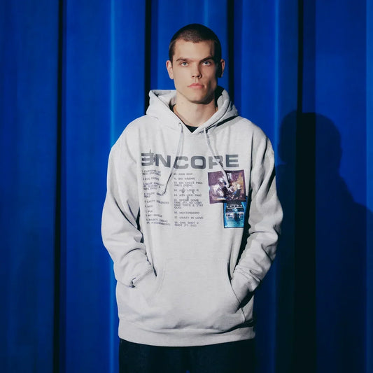 Man wearing the grey Eminem Encore 20th Anniversary hoodie with track list and album art