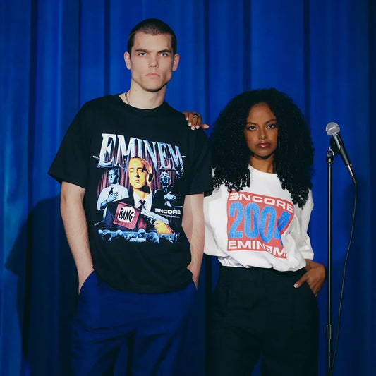 Two models in Eminem Encore T-shirts on a blue-curtained stage, photo and logo prints