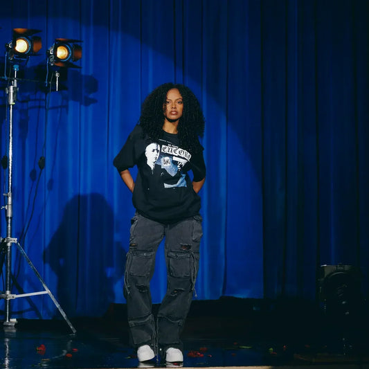 Model in the black Eminem Encore Clippings T-shirt under stage lights