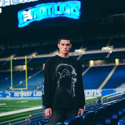 Man wearing the black Eminem x Detroit Lions Silhouette long sleeve on the field
