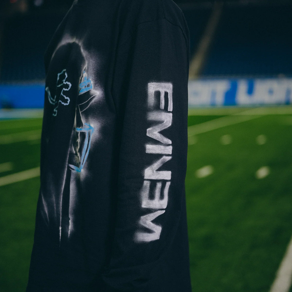 Sleeve detail of the Eminem x Detroit Lions Silhouette long sleeve with blue Eminem lettering