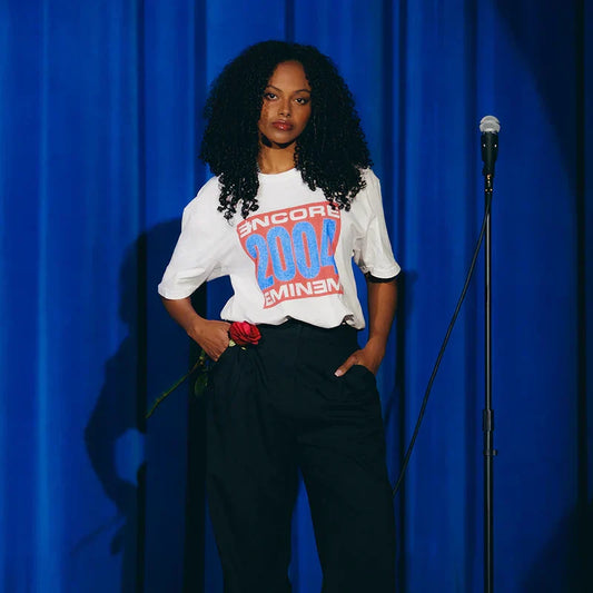 Woman wearing the white Encore 2004 vintage Eminem T-shirt with red and blue block logo