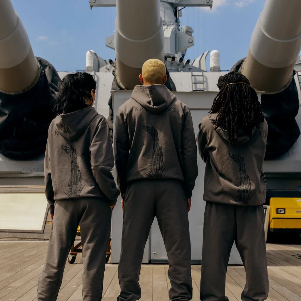 Back view of three models in taupe Eminem Kamikaze x Standard Issue hoodies