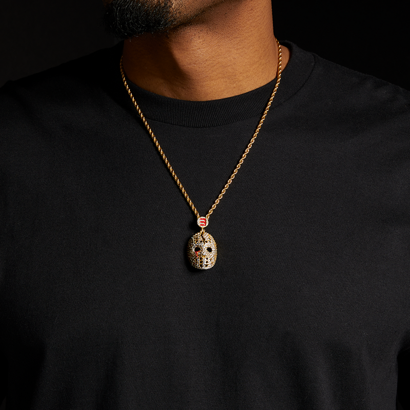 Man wearing the gold Eminem hockey mask diamond pendant and chain over a black tee