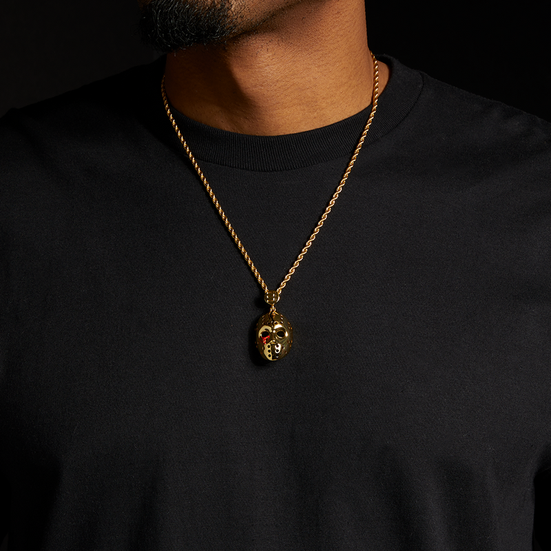 Man wearing the gold Eminem hockey mask pendant and chain over a black tee