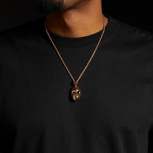 Man wearing the gold Eminem hockey mask pendant and chain over a black tee