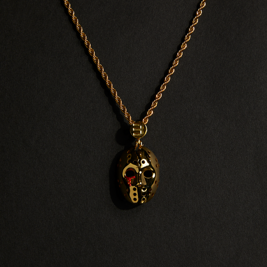 Gold Eminem hockey mask pendant with red accents on a gold rope chain