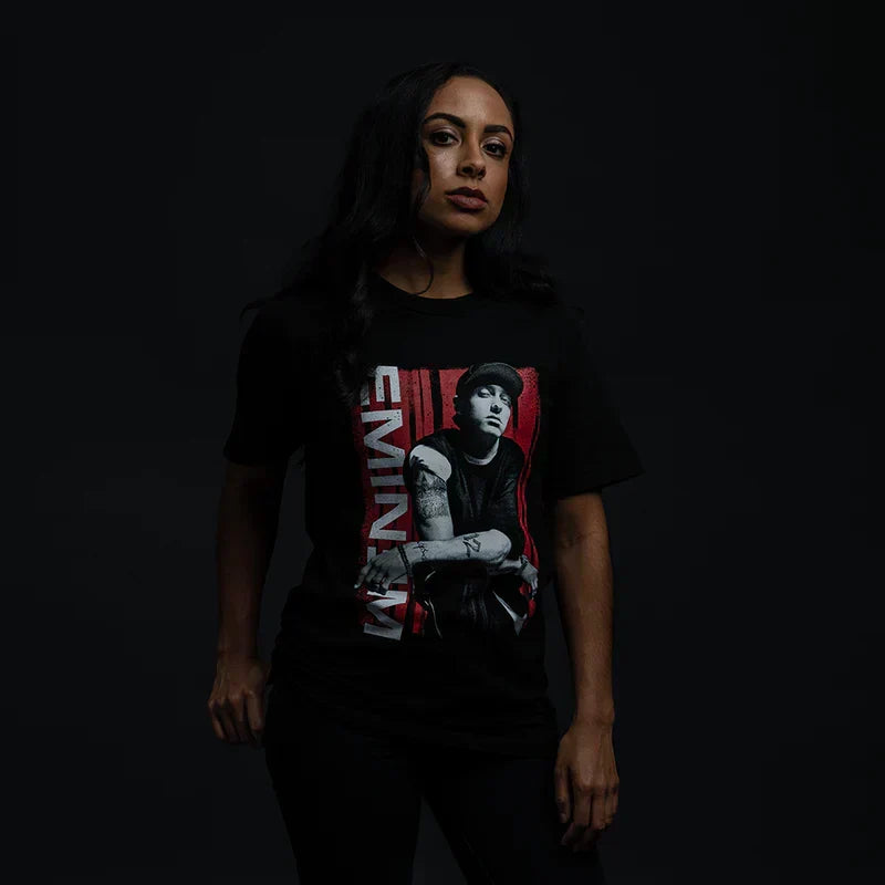 Woman wearing the black Eminem Graphic Lean T-shirt, red panel photo and vertical Eminem logo